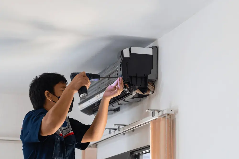 Technician diagnosing a split air conditioner in a Dubai home