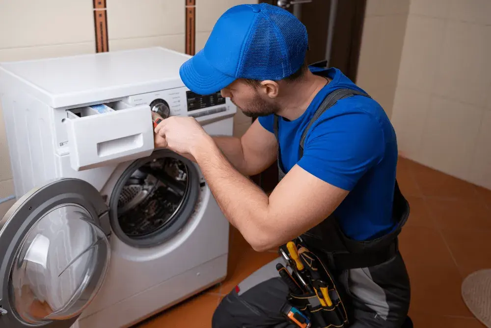 One Click Dubai technician repairing a front-load washing machine