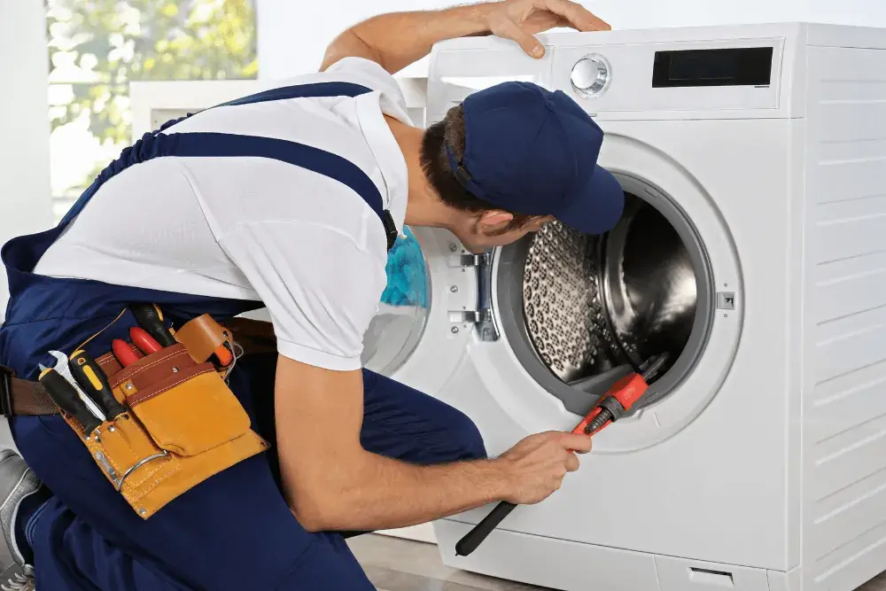 Technician repairing a washing machine