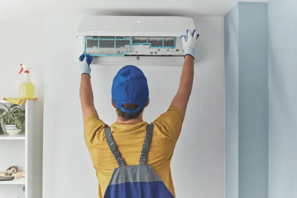 Technician servicing a split AC unit