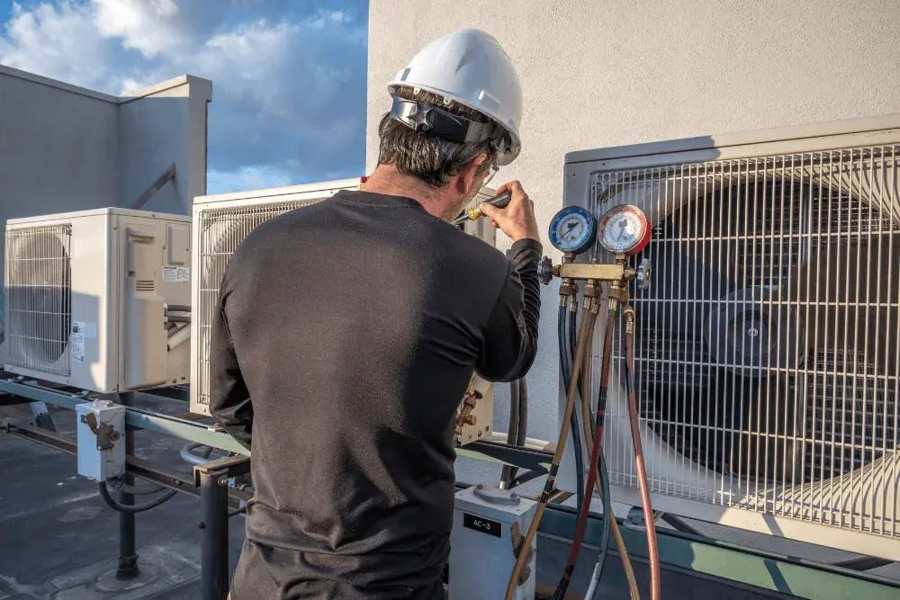 One Click Dubai engineer taking readings on a rooftop chiller